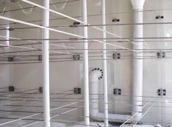 Inside a GRP panel tank showing internal stays and roof support pipes