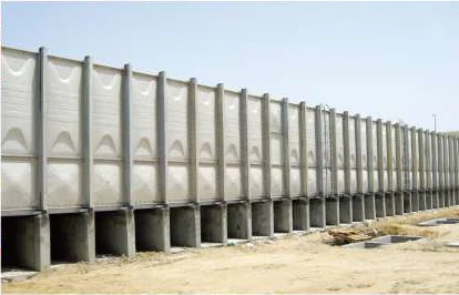 Long GRP panel tank raised on concrete plinths outdoors